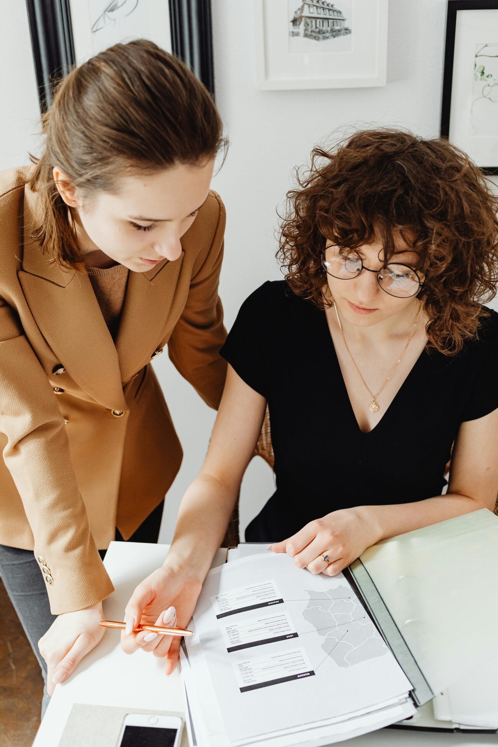 a woman looking at a piece of tax paper